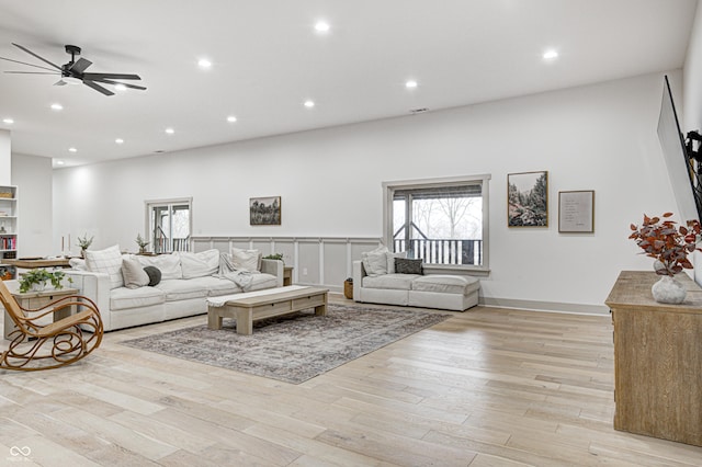 living room with ceiling fan and light wood-type flooring