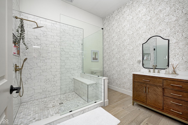 bathroom featuring vanity, hardwood / wood-style floors, and tiled shower