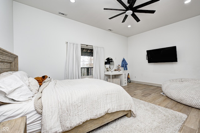 bedroom with ceiling fan and light hardwood / wood-style floors