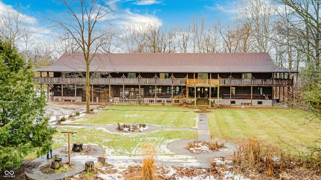 rear view of house with a wooden deck, a yard, and a patio area