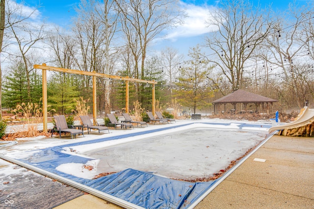 view of swimming pool with a gazebo and a water slide