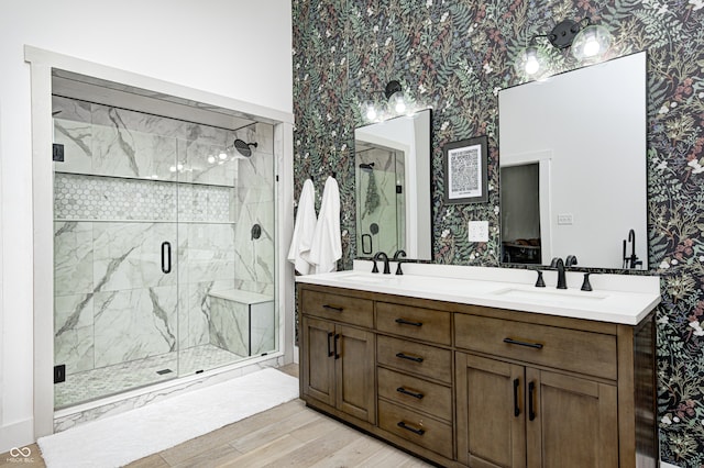 bathroom featuring vanity, hardwood / wood-style flooring, and a shower with shower door