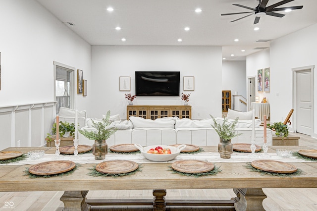 dining area featuring wood-type flooring and ceiling fan