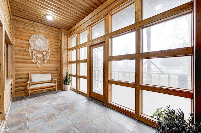 doorway to outside with wood ceiling