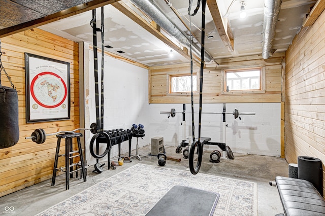 exercise area featuring wood walls