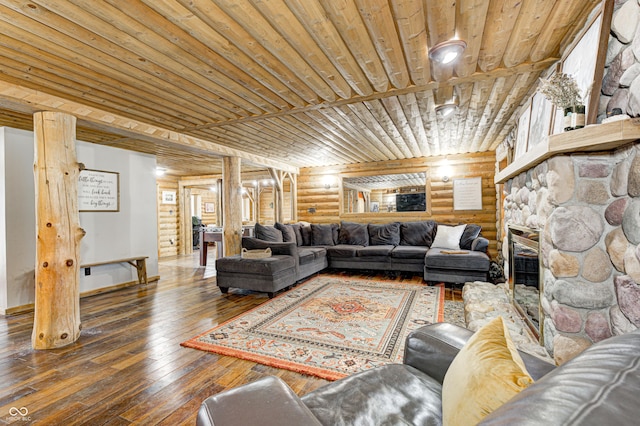 living room featuring wood ceiling, a stone fireplace, dark hardwood / wood-style floors, and log walls