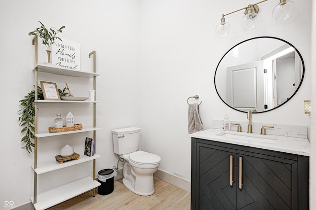 bathroom with vanity, hardwood / wood-style flooring, and toilet