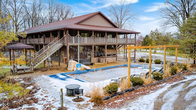 snow covered house with a jacuzzi