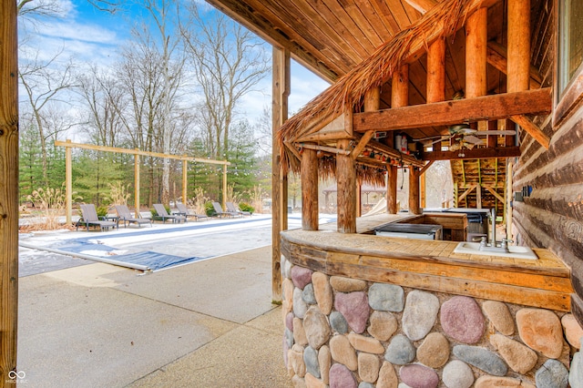 view of patio with a covered pool and ceiling fan