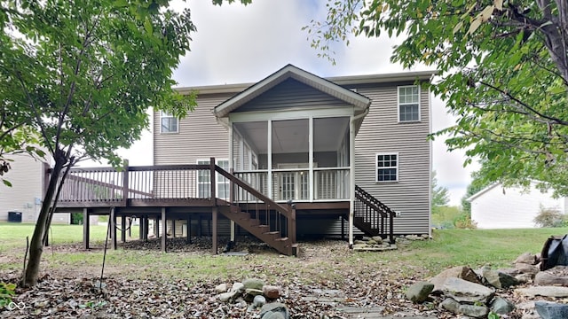 rear view of house featuring a sunroom and a deck