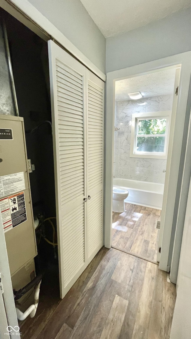 corridor with hardwood / wood-style floors