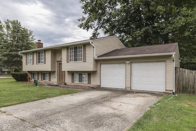 split foyer home featuring a garage and a front lawn