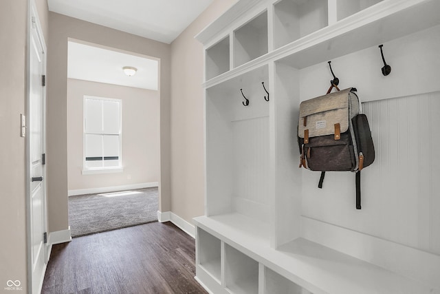 mudroom featuring dark colored carpet