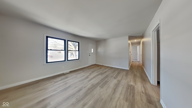 unfurnished room with light wood-type flooring