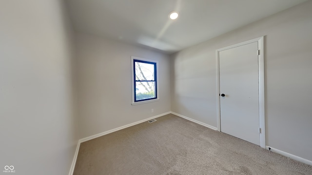 unfurnished room featuring carpet