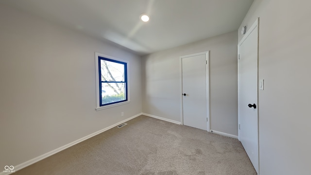 unfurnished bedroom with light carpet