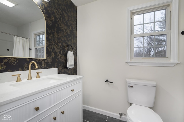 bathroom with vanity, toilet, and tile patterned flooring