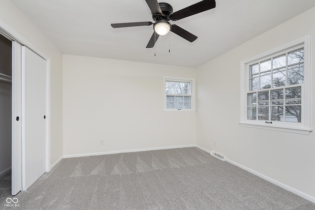 unfurnished bedroom featuring a closet, ceiling fan, and carpet