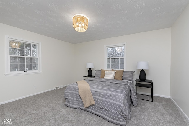 carpeted bedroom with a textured ceiling