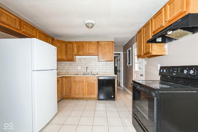 kitchen featuring tasteful backsplash, sink, light tile patterned floors, and black appliances