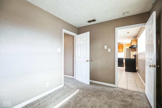 unfurnished bedroom featuring light carpet