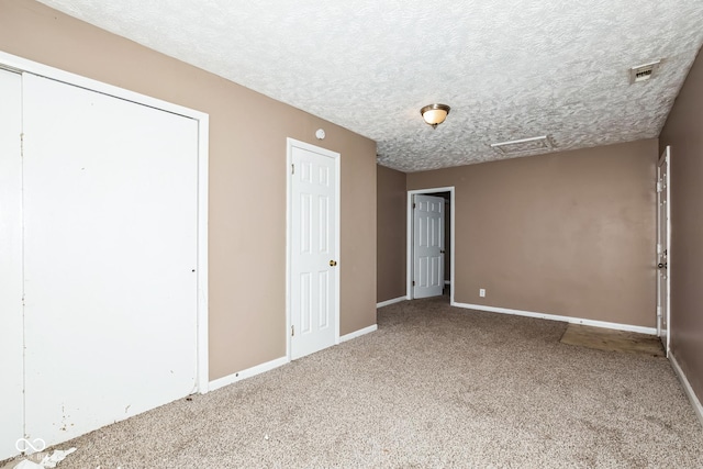 unfurnished bedroom featuring carpet floors and a textured ceiling