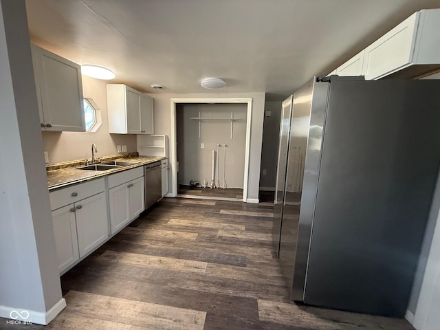 kitchen featuring white cabinetry, stainless steel appliances, dark hardwood / wood-style floors, and sink