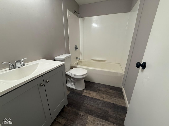 full bathroom featuring vanity, hardwood / wood-style flooring, toilet, and shower / bathing tub combination