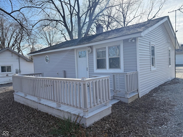 rear view of property with a wooden deck