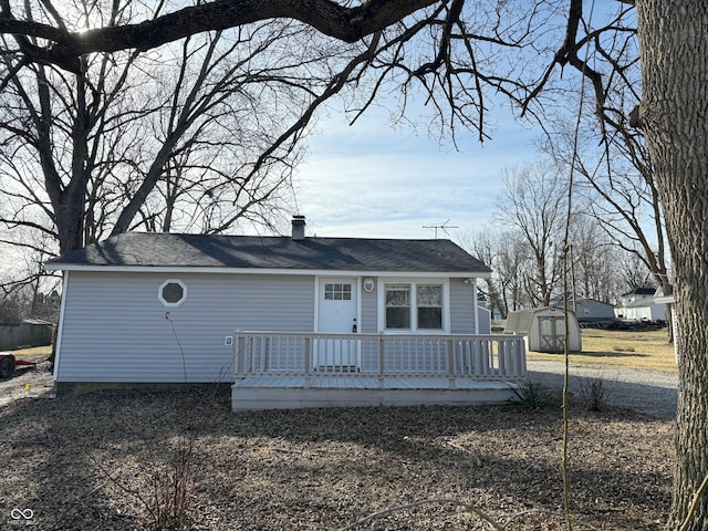 view of front facade with a deck and a storage shed