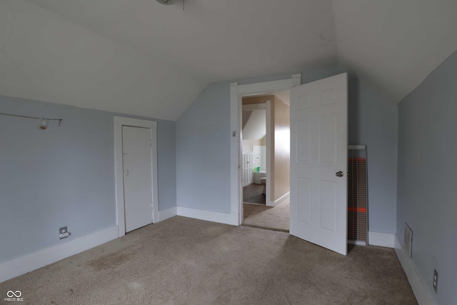 bonus room featuring baseboards, lofted ceiling, and carpet flooring