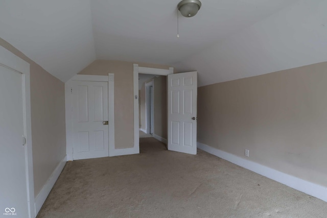 additional living space featuring lofted ceiling, baseboards, and carpet floors