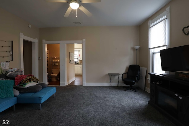 sitting room with visible vents, baseboards, a ceiling fan, and carpet flooring