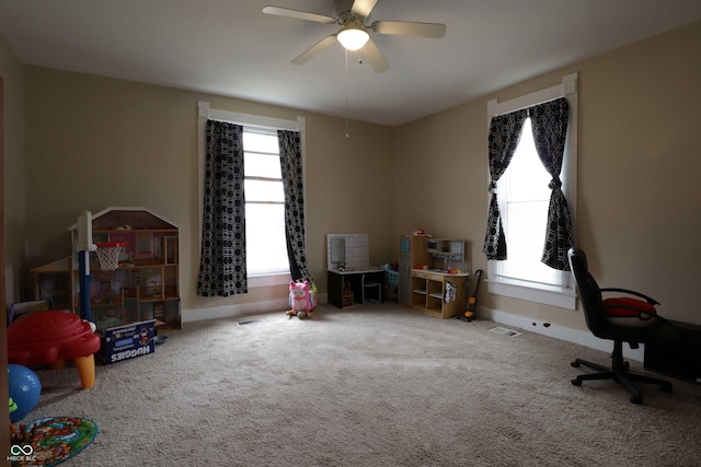 playroom featuring visible vents, carpet floors, baseboards, and ceiling fan