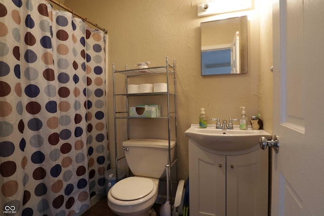 bathroom featuring vanity, toilet, and a shower with curtain