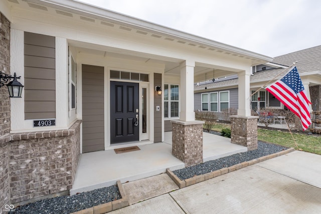 view of exterior entry with a porch