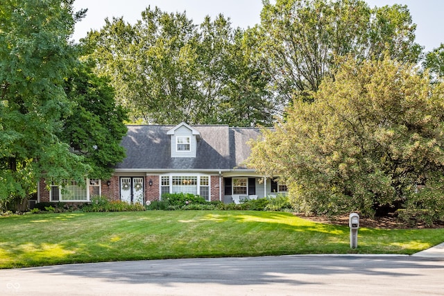 new england style home with a front lawn