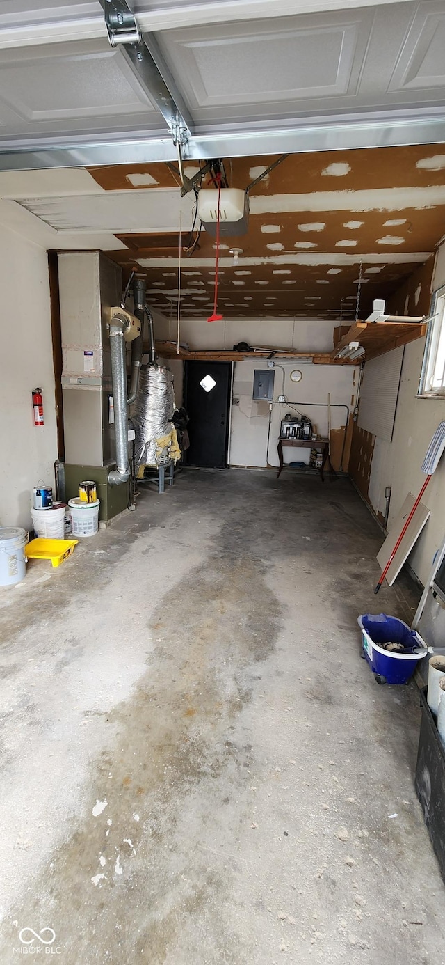 garage featuring heating unit and electric panel