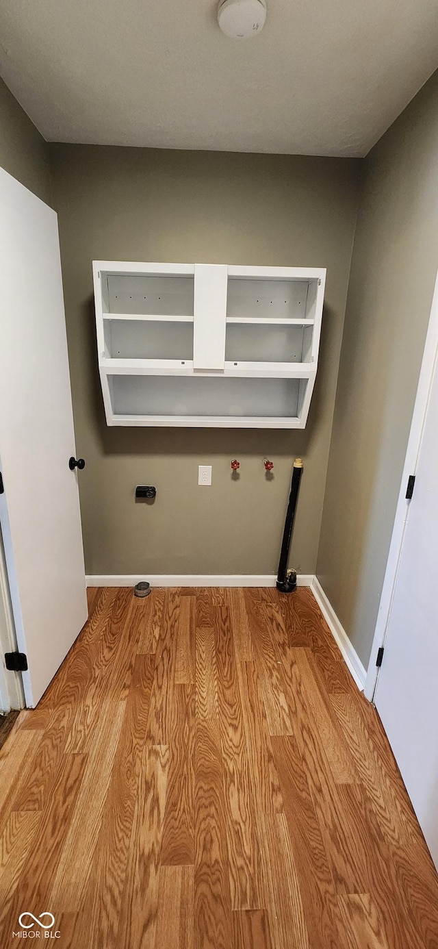 laundry area with light wood-type flooring