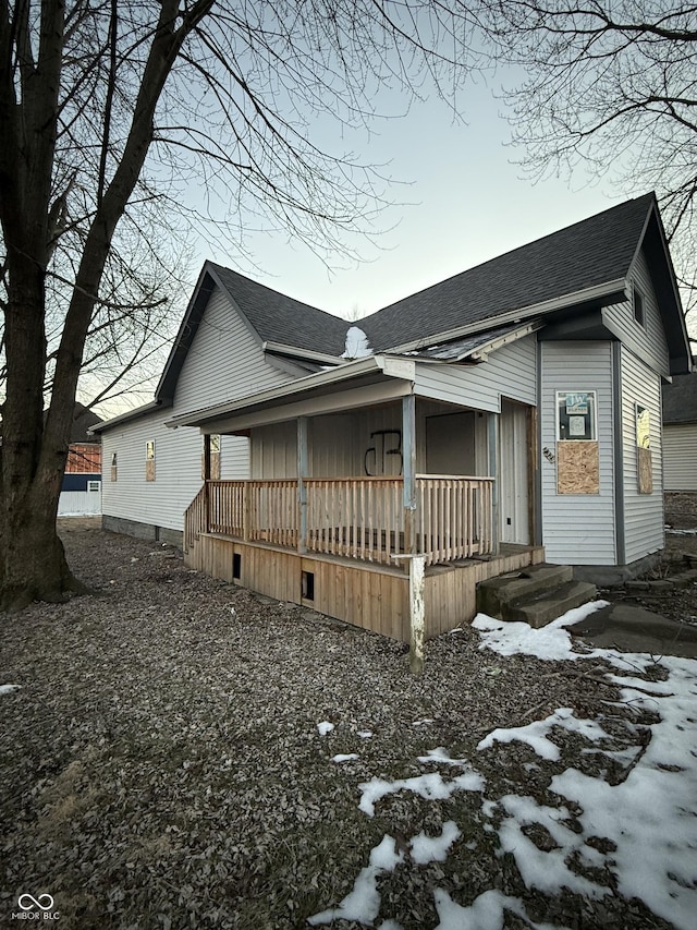 view of snow covered exterior featuring a porch