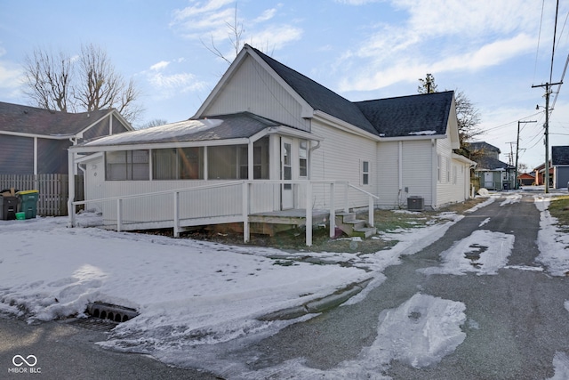 exterior space with central AC and a sunroom