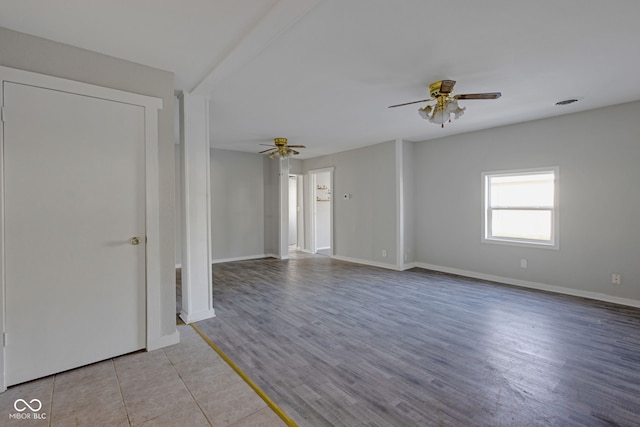 spare room featuring ceiling fan and light hardwood / wood-style flooring