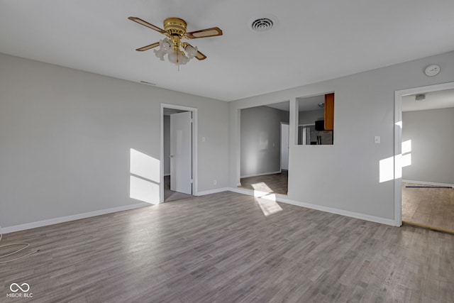 empty room featuring light hardwood / wood-style flooring and ceiling fan