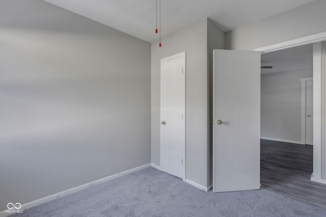 unfurnished bedroom featuring dark carpet