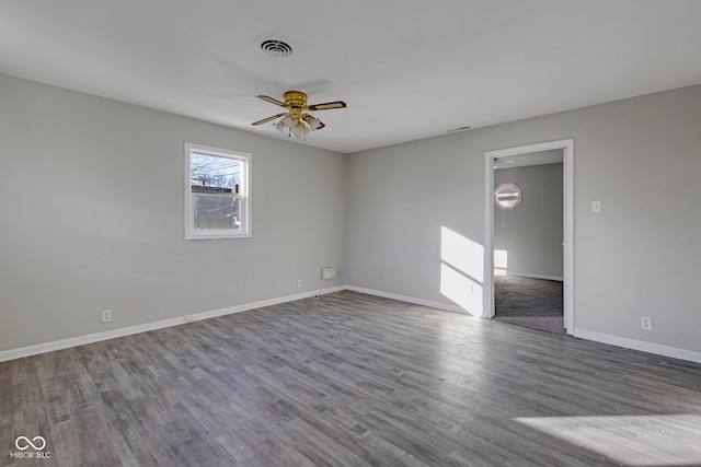 empty room featuring hardwood / wood-style flooring and ceiling fan