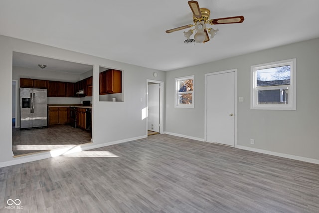 unfurnished living room featuring ceiling fan and light wood-type flooring