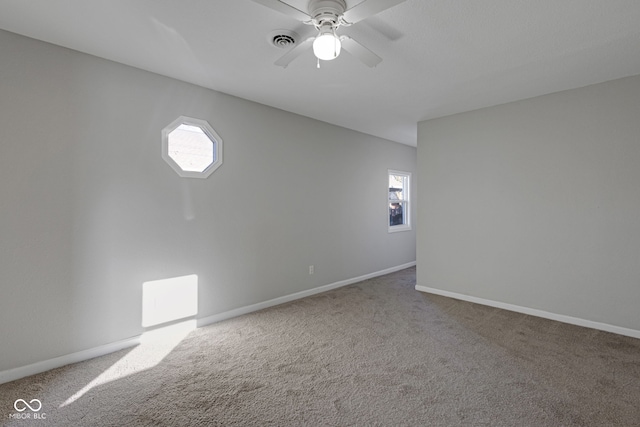 unfurnished room featuring ceiling fan and carpet