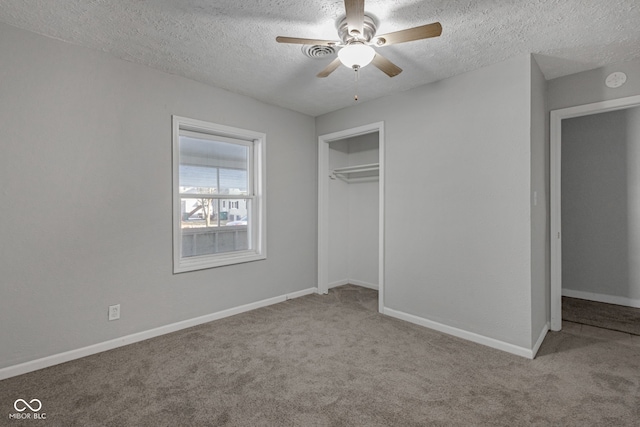 unfurnished bedroom with ceiling fan, light colored carpet, a closet, and a textured ceiling