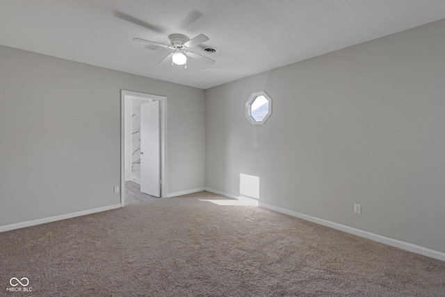 carpeted empty room with ceiling fan