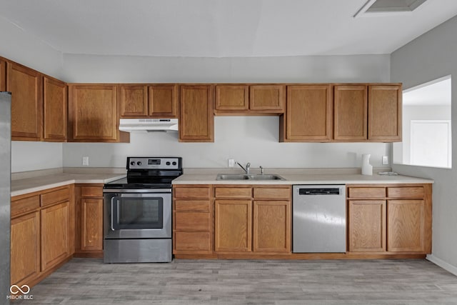 kitchen featuring sink, light hardwood / wood-style flooring, and appliances with stainless steel finishes